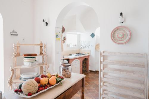 a kitchen with a bowl of fruit on a table at Villa Giusy in Positano