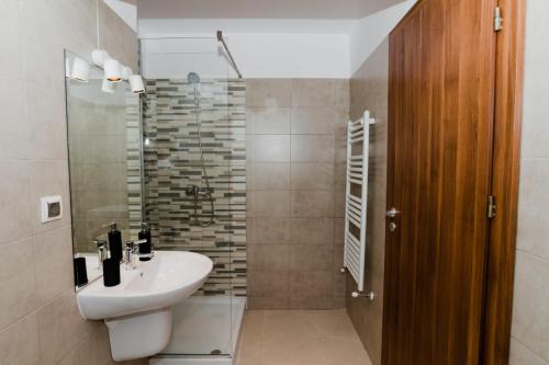 a bathroom with a sink and a toilet and a shower at Homeland Apartments VIVA in Cluj-Napoca