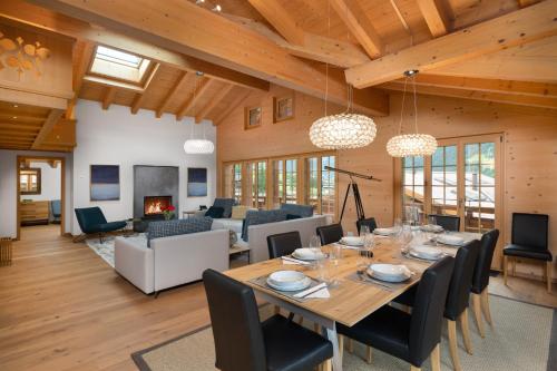 a dining room and living room with a table and chairs at Chalet Alia and Apartments-Grindelwald by Swiss Hotel Apartments in Grindelwald