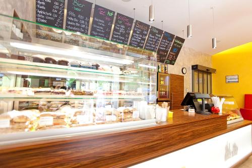 a bakery with a counter with pastries behind it at Hotel Müller in Hohenschwangau