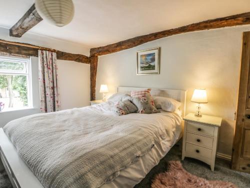 a bedroom with a large bed and a window at Wren's Nest in Thirsk