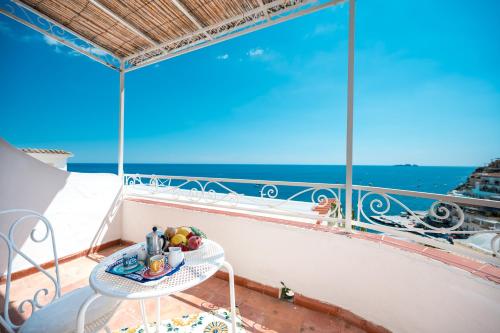 a balcony with a table with a bowl of fruit on it at Villa Giusy in Positano