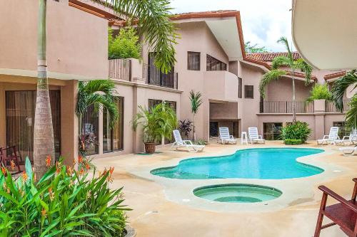 a courtyard with a swimming pool in front of a building at The Cove 9 at Playa Ocotal in Coco