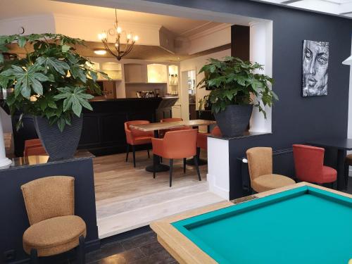 a dining room with a pool table and chairs at Den Hoge Doorn in Harelbeke
