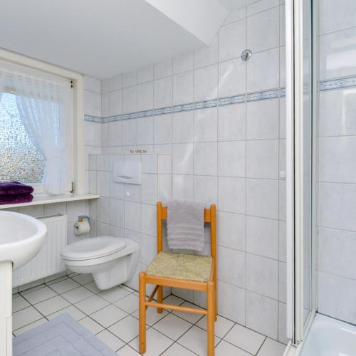 a bathroom with a toilet and a sink and a shower at Wohnung West in Westerland