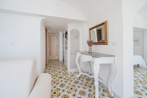 a white room with a table and a mirror at Villa Giusy in Positano