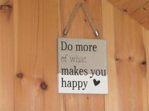 a sign that says do more of what makes you happy at Harlosh Hideaways - Aurora Pod in Harlosh