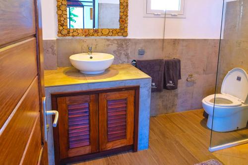 a bathroom with a sink and a toilet at Les Terrasses d'Ulysse in Hell-Ville