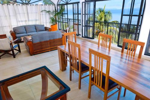 a living room with a table and chairs and a couch at Les Terrasses d'Ulysse in Hell-Ville