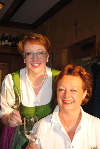 a woman holding a glass of wine next to another woman at Panoramahotel Steirerland in Kitzeck im Sausal