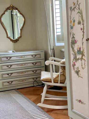 a dressing room with a chair and a mirror at apartman Cedra in Izola