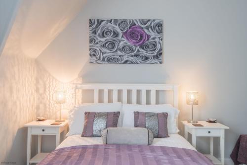 a bedroom with a bed with two night stands and two lamps at Pitch Perfect by Bloom Stays in Canterbury