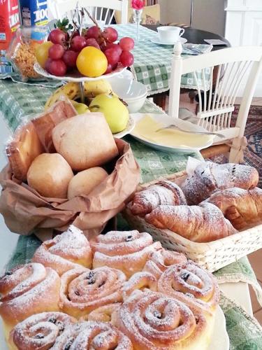 a table with baskets of bread and pastries on it at B&B Armonie in Ranica