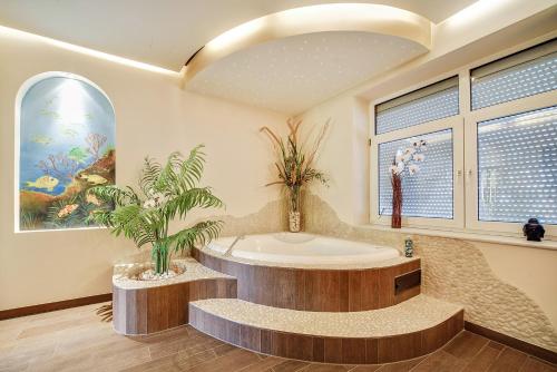 ein Bad mit einer Badewanne mit einer Pflanze in der Unterkunft Mozart, Salzburg und Wellness für bis zu 7 Gäste in Salzburg