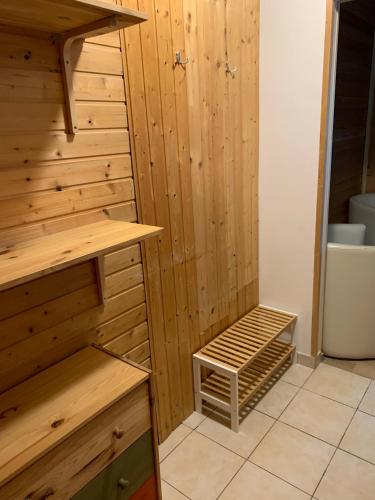 a sauna with a wooden wall and a wooden shelf at Penzion a Restaurace Vyhlídka in Železná Ruda