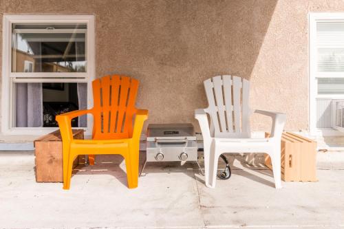 two chairs sitting next to each other next to a wall at Sunny Boho Chic West Hollywood Flat! in Los Angeles