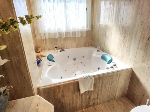 a white tub in a bathroom with a window at Aguamarina in Peñíscola