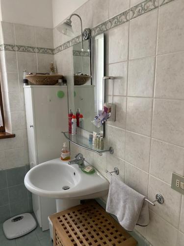 a bathroom with a white sink and a mirror at Ca’ Alba in Sestola