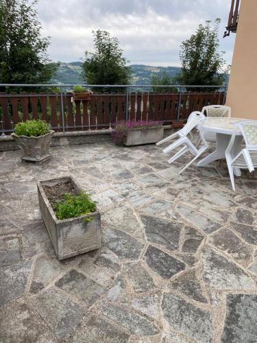 a patio with a table and chairs on a patio at Ca’ Alba in Sestola