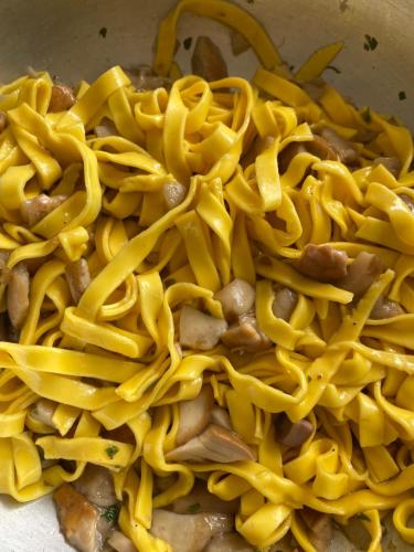a pile of noodles and mushrooms in a pan at Ca’ Alba in Sestola
