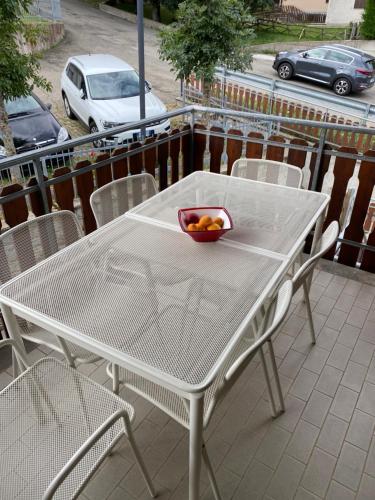 a table and chairs with a bowl of fruit on it at Ca’ Alba in Sestola