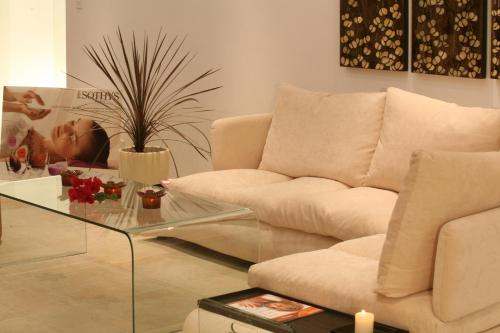 a living room with a couch and a glass table at Aphrodite Sands in Mandria