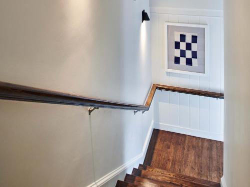 a hallway with stairs and a picture on the wall at Harbor View Hotel in Edgartown