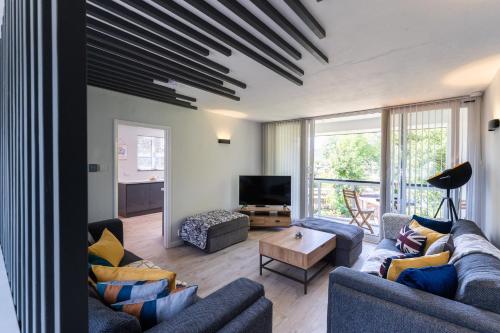 a living room with two couches and a tv at Thornbeck Manor Lake Windermere in Windermere