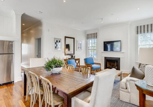 a kitchen and living room with a wooden table and chairs at Harbor View Hotel in Edgartown