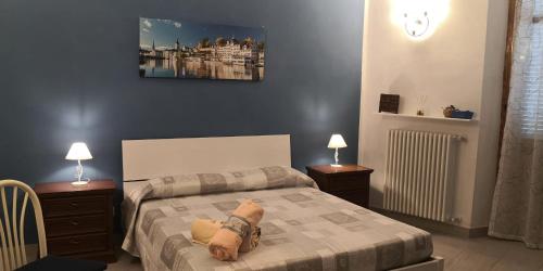 a bedroom with a bed with two night stands and two lamps at Casa Martina in Asti