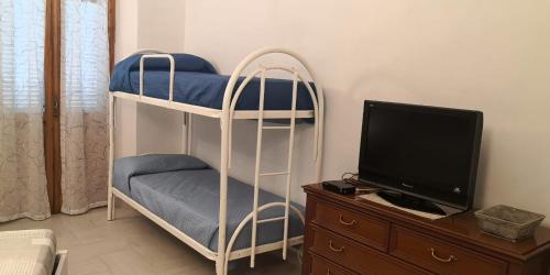 a room with two bunk beds and a tv at Casa Martina in Asti