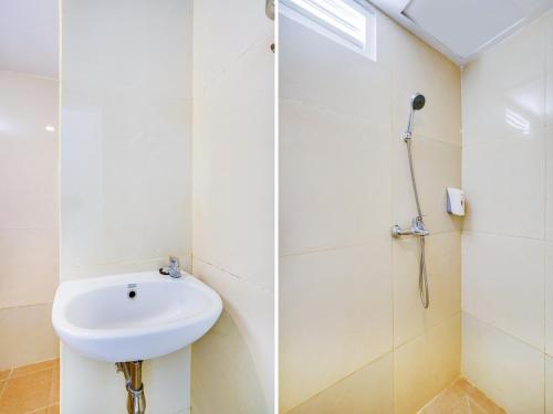 a bathroom with a sink and a shower at LG Hotel Jember in Berpodak