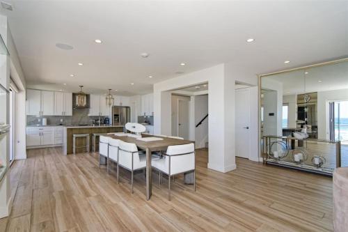 a kitchen and dining room with a table and chairs at Ocean Villas Beach Front in Carlsbad