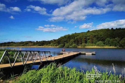 a dock on a lake with a person on it at Glenmount Castleblayney in Castleblayney