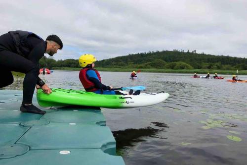 a man and a child in a kayak on the water at Glenmount Castleblayney in Castleblayney