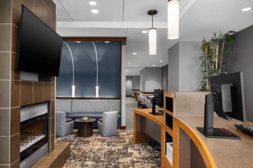 a lobby with a waiting room with a tv at Hyatt Place Boston/Braintree in Braintree