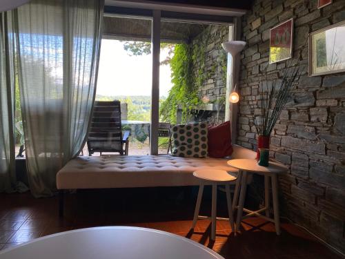 a living room with a couch and a window at Gemütliche Ferienwohnung mit Terrasse und Seeblick in Velden am Wörthersee