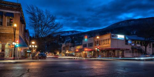 a city street at night with traffic lights and buildings at Prestige Inn Nelson in Nelson
