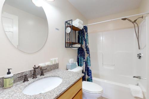 a bathroom with a sink and a toilet and a mirror at Belle Of Maine Condo 106 in Wells
