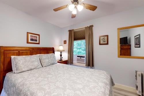 a bedroom with a bed and a ceiling fan at Belle Of Maine Condo 106 in Wells