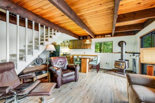 a living room with a staircase and a fireplace at Sound Retreat in Shelton