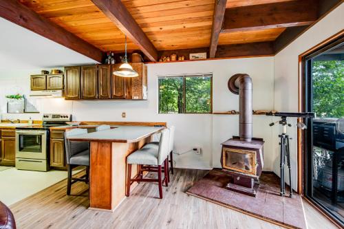 a kitchen with a wood stove in the middle at Sound Retreat in Shelton