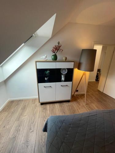 a bedroom with a bed and a dresser in a room at MYSTAY BERLIN Müggelheim in Berlin