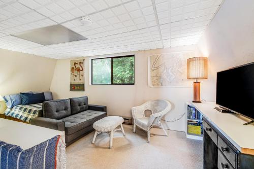 a living room with a couch and a tv at Sound Retreat in Shelton