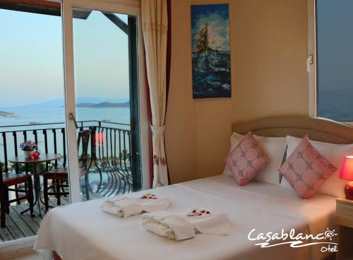 a bedroom with a bed with towels on it at Hotel Casablanca in Gümbet