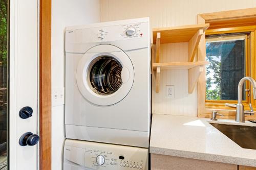 a washer and dryer in a kitchen next to a sink at Sound View in South Beach