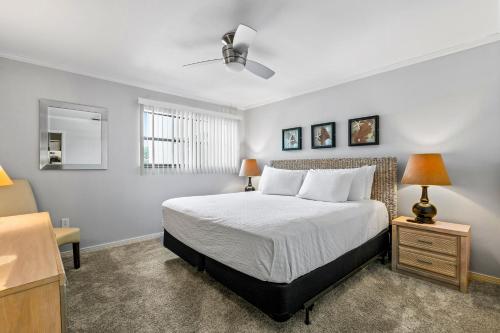 a bedroom with a bed and two lamps and a dresser at Dune Villas 7A in Santa Rosa Beach