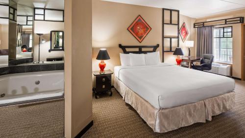 a hotel room with a bed and a bath tub at Best Western Galena Inn & Suites in Galena