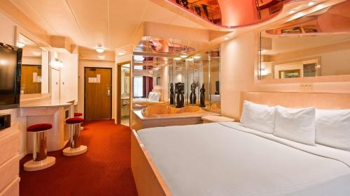 a bedroom with a large bed and a bathroom at Best Western Galena Inn & Suites in Galena