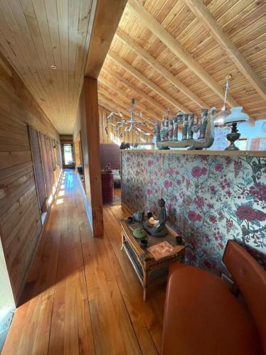 a living room with a couch and a table at Pucontours River Lodge in Pucón